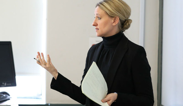 A Catholic ϲapp professor teaching a class.
