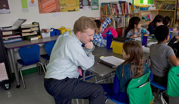 A Catholic ϲapp student in an elementary school classroom getting hands-on experience.