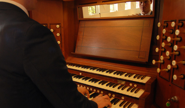 A Catholic ϲapp student practicing the organ.